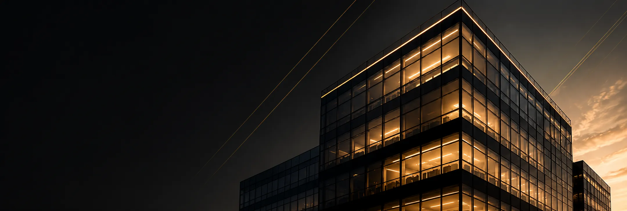 Modern glass office building at dusk
